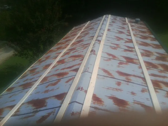 Rusted metal roof panels with new wood purlins before replacement — Storm Damage Roof Repair in Prospect by Roofing Brothers