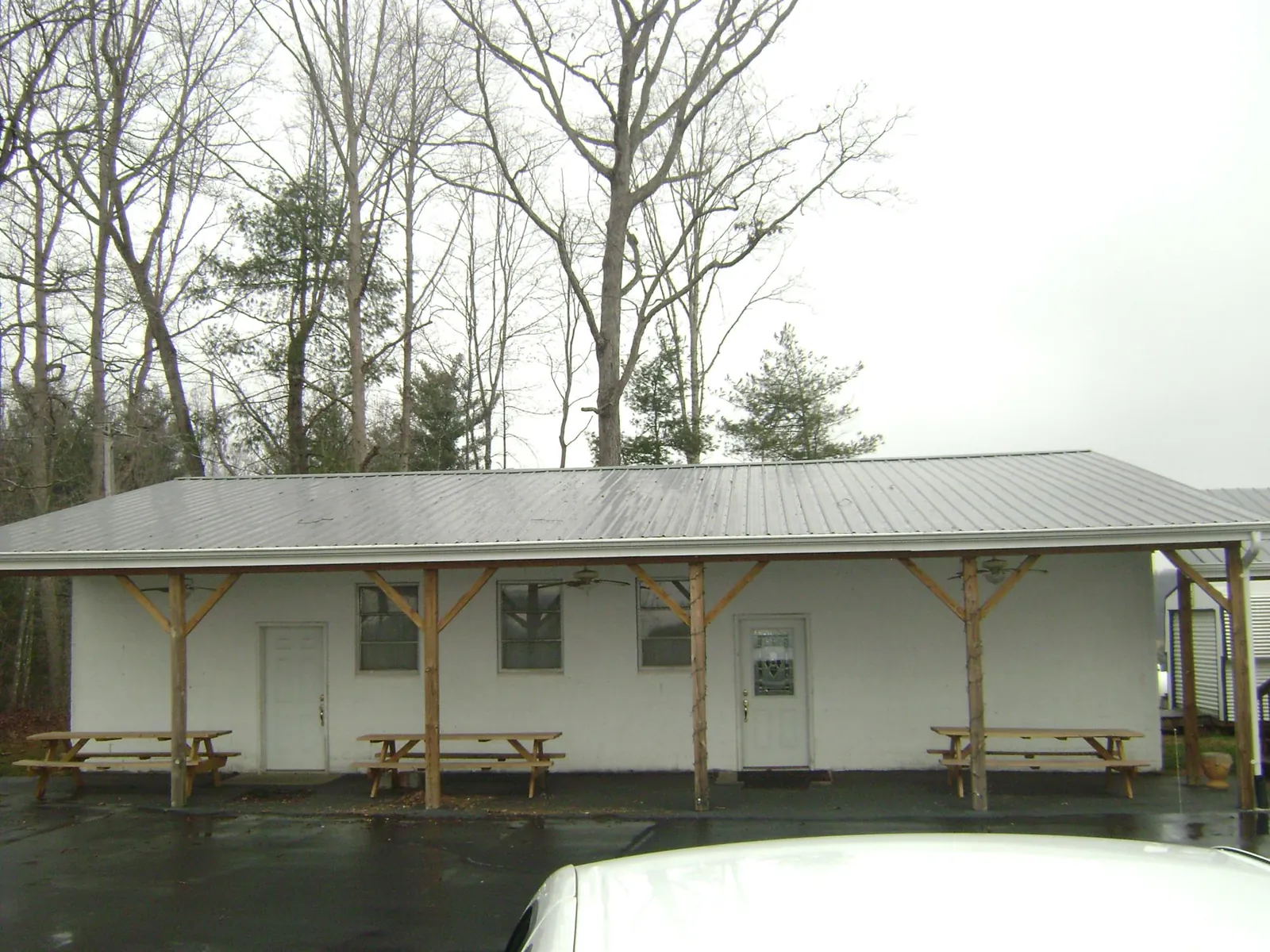 Gray metal roof over a block building with a timber post porch in Prospect